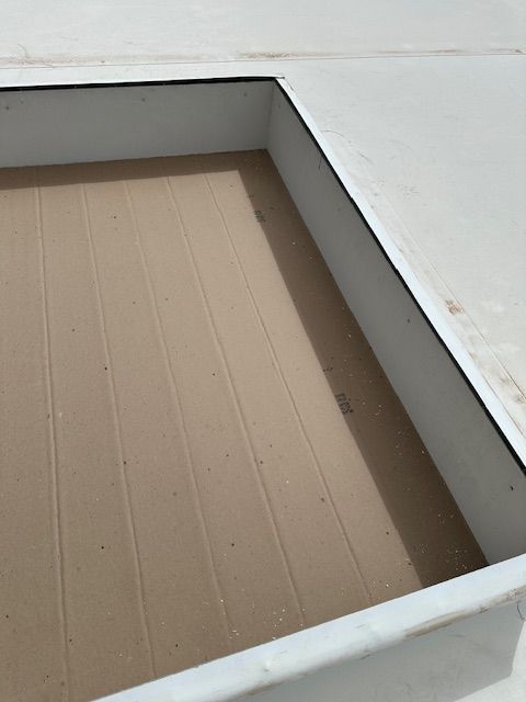 White-trimmed square opening with a beige floor or panel inside.