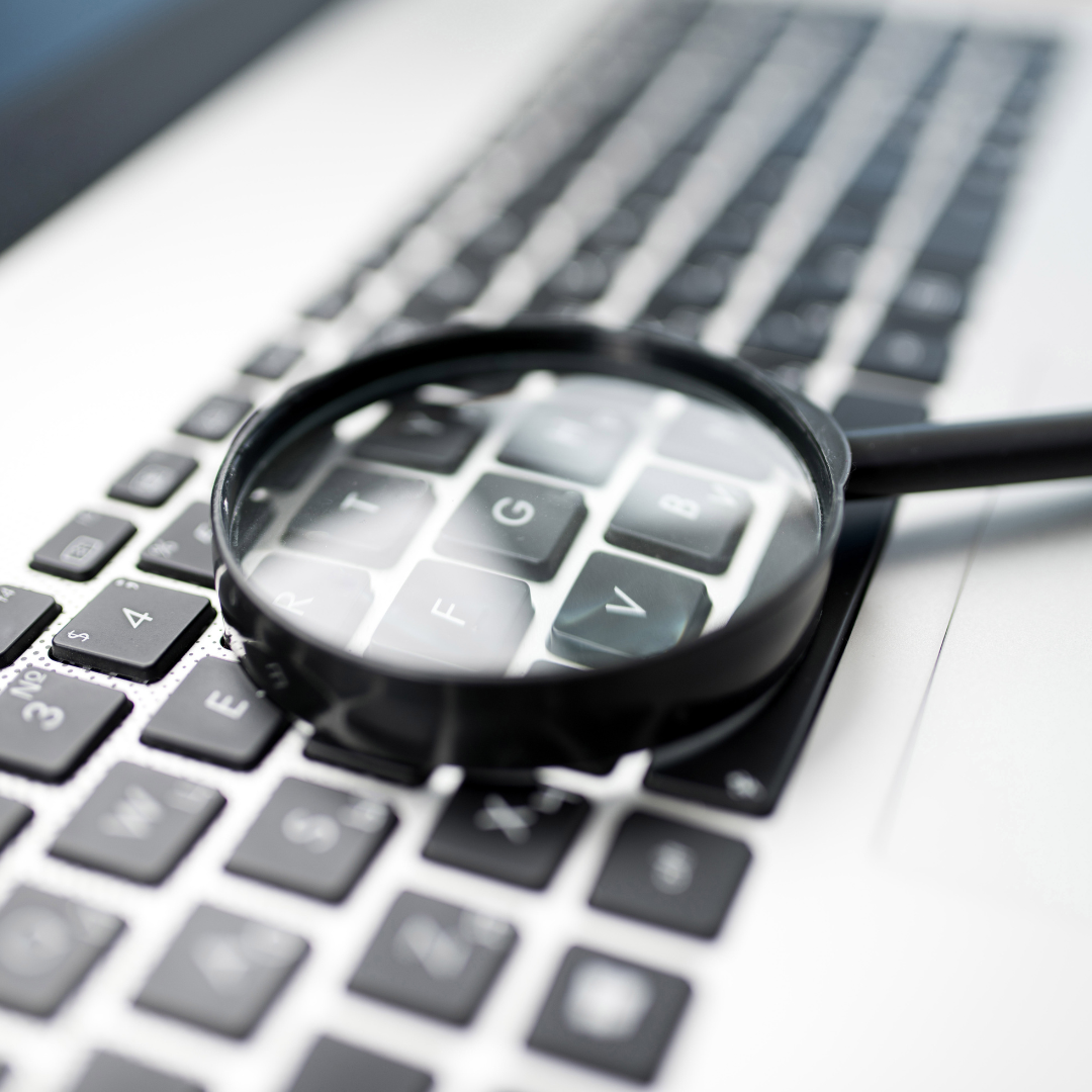 magnifying glass on computer keyboard