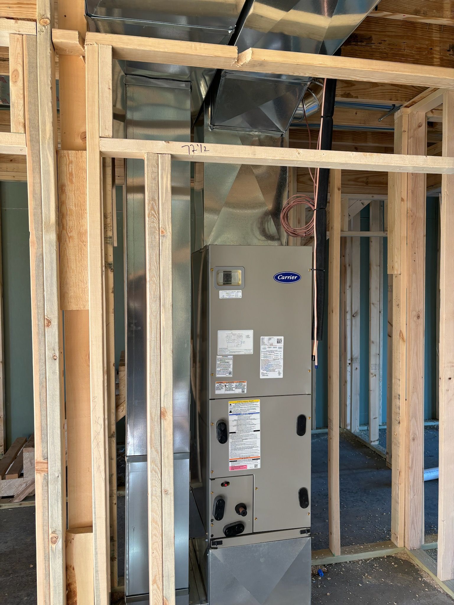 A furnace inside a wooden frame in a construction site.