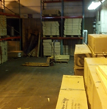 A large warehouse filled with lots of boxes and pallets