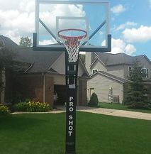 A basketball hoop is sitting in front of a house.