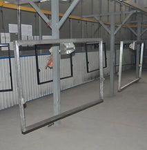 A row of metal frames hanging from the ceiling of a building.