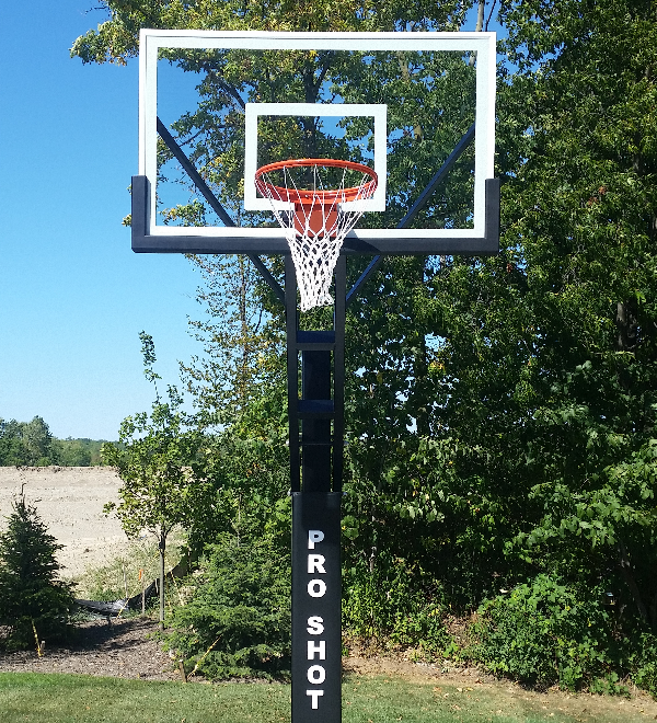 A basketball is going through the net of a basketball hoop.