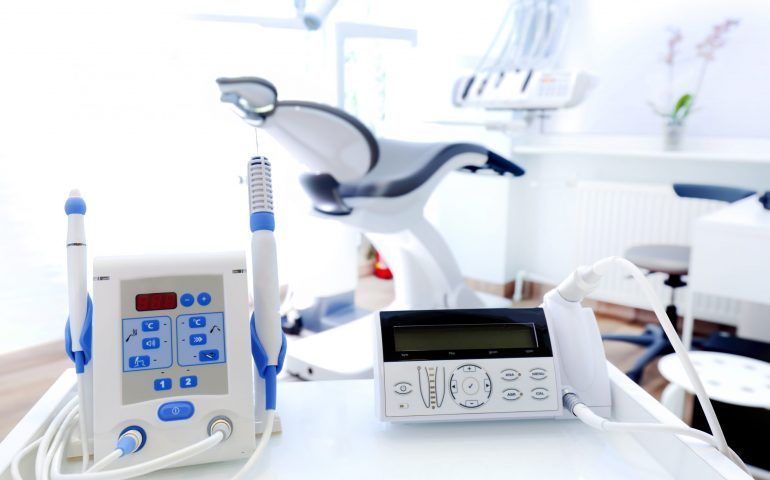 A dental office with a dental chair and dental equipment