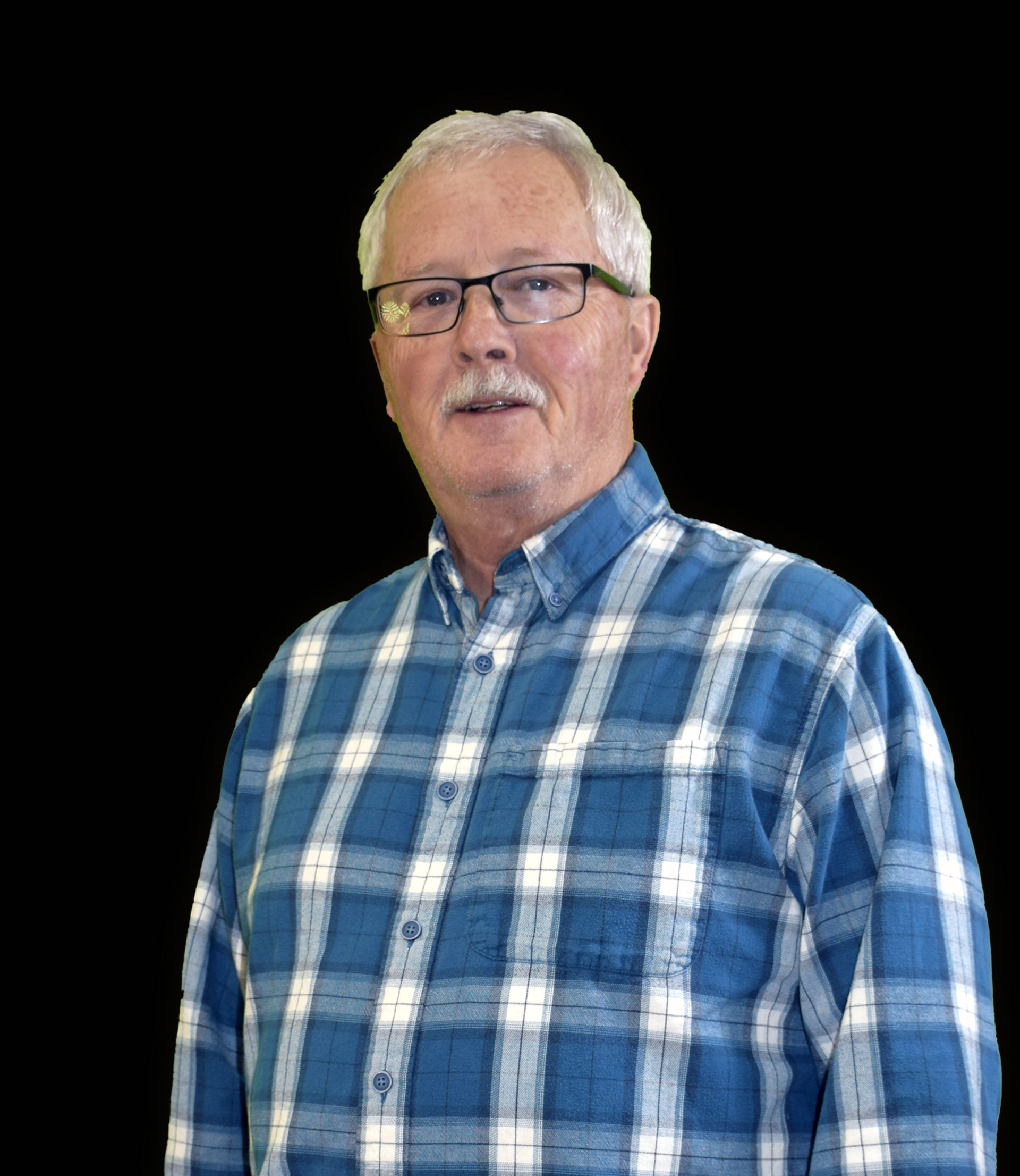 An older man wearing glasses and a blue shirt