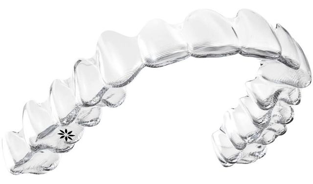 Close-up of a transparent Invisalign aligner