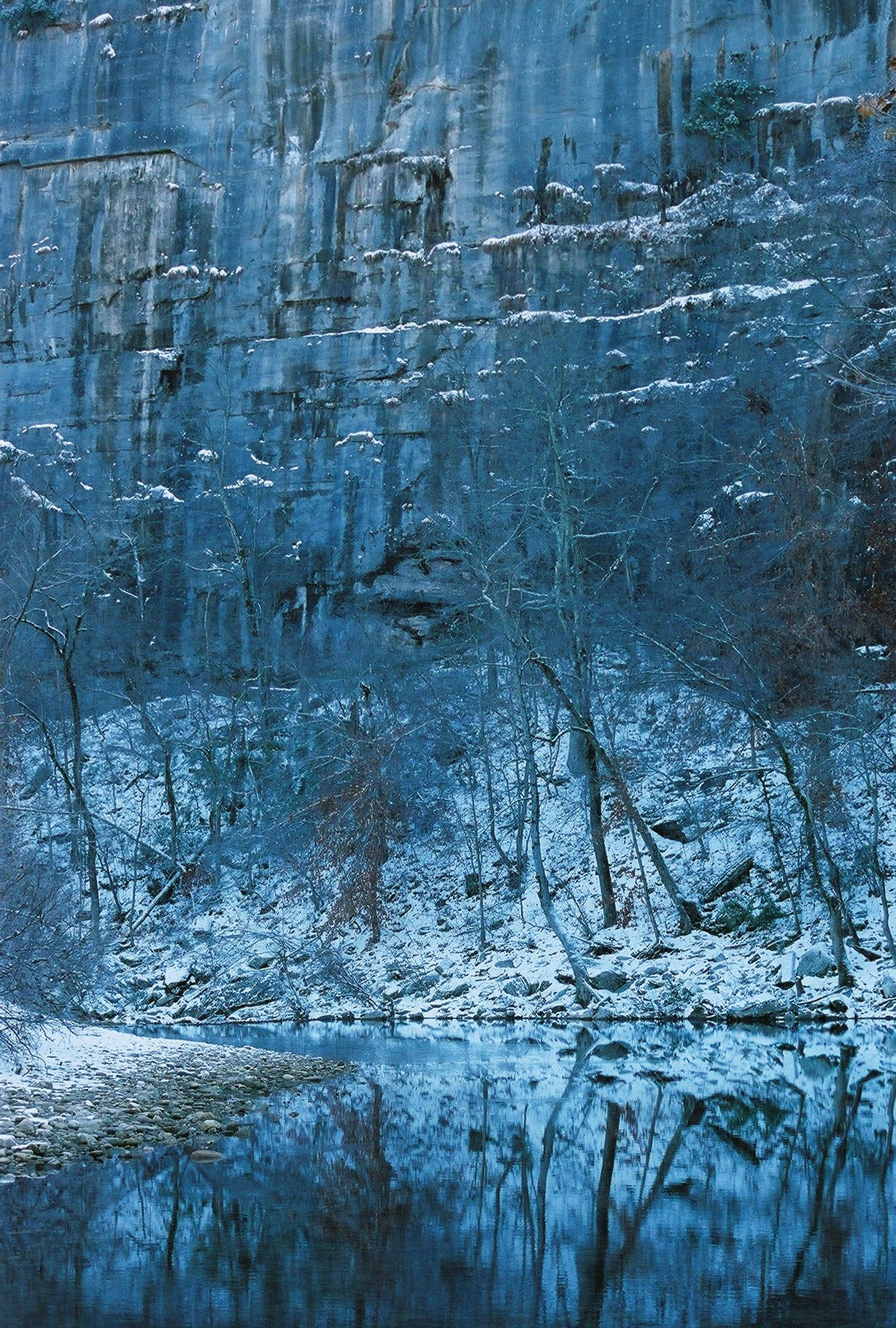 Blue textured abstract landscape with icy reflections and a snowy foreground