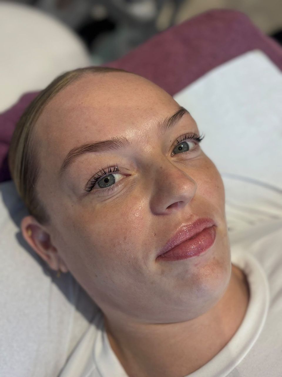 The same client's lashes after a lash lift and tint, lifted from the root and darker