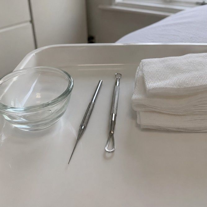 Professional milia extraction tools laid out on a clinical treatment tray at a private skin clinic in Nottingham