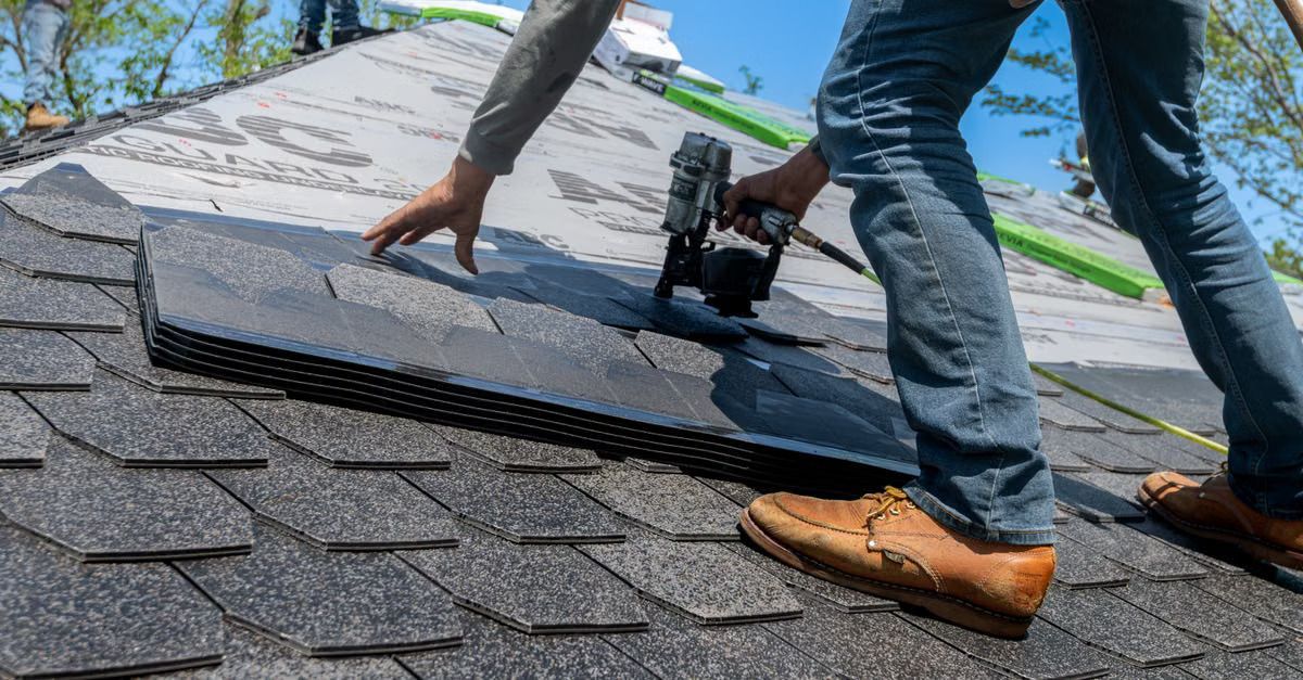 A completed residential roof replacement with new asphalt shingles

