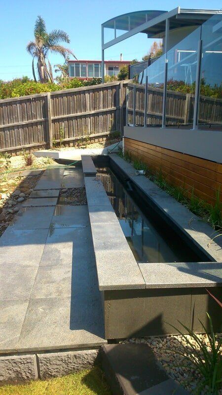 A Pond Beside the Backyard of A House — Peter Phillips Landscape Design in Bomaderry, NSW