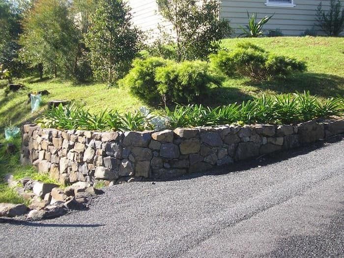 A Stone Wall Along the Side of A Road — Peter Phillips Landscape Design in Vincentia, NSW