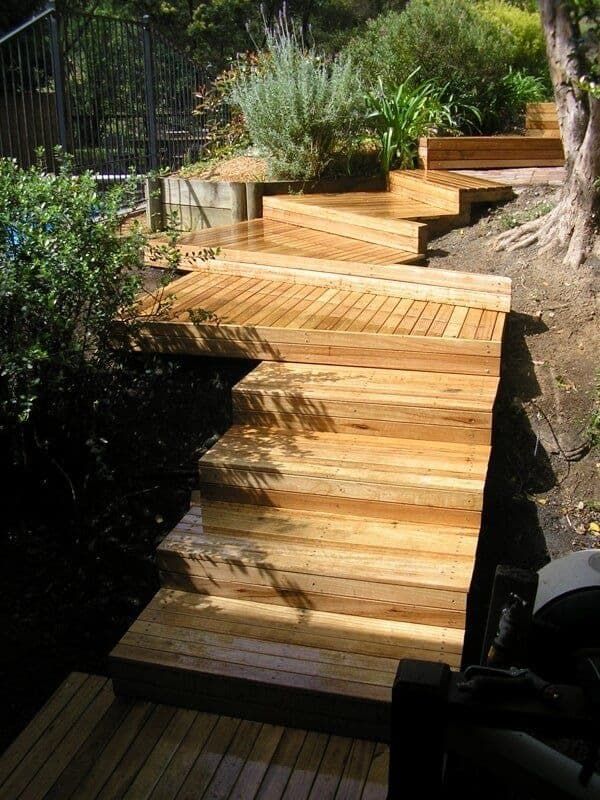 A Wooden Walkway Leading to A Fenced in Area — Peter Phillips Landscape Design in Vincentia, NSW