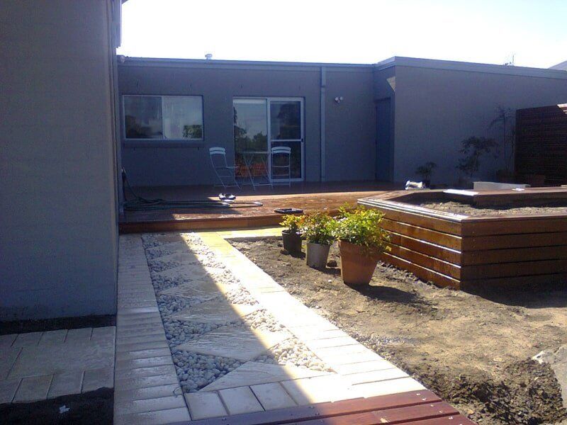 A House with A Walkway Leading to The Backyard — Peter Phillips Landscape Design in Bomaderry, NSW