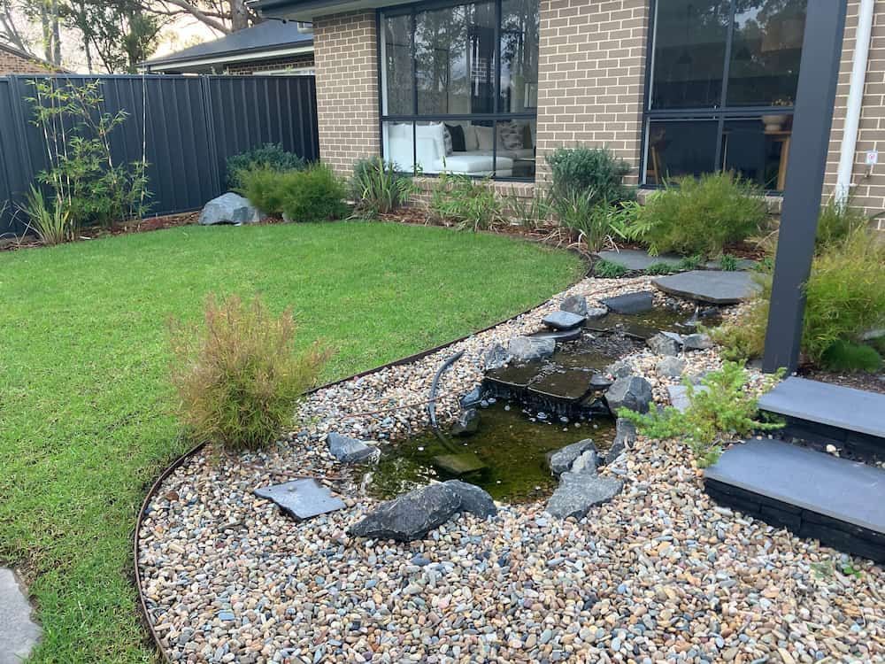 There is a Pond in the Backyard of a House — Peter Phillips Landscape Design in Bomaderry, NSW