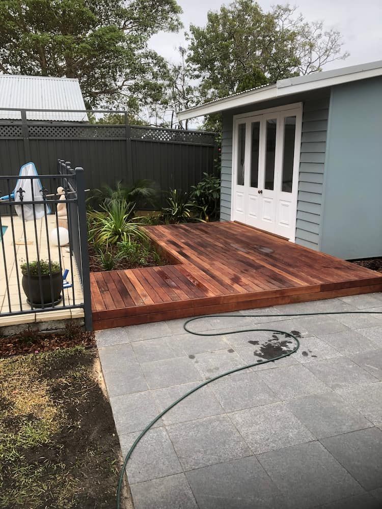 A Wooden Deck is Being Built in Front of a House — Peter Phillips Landscape Design in Bomaderry, NSW