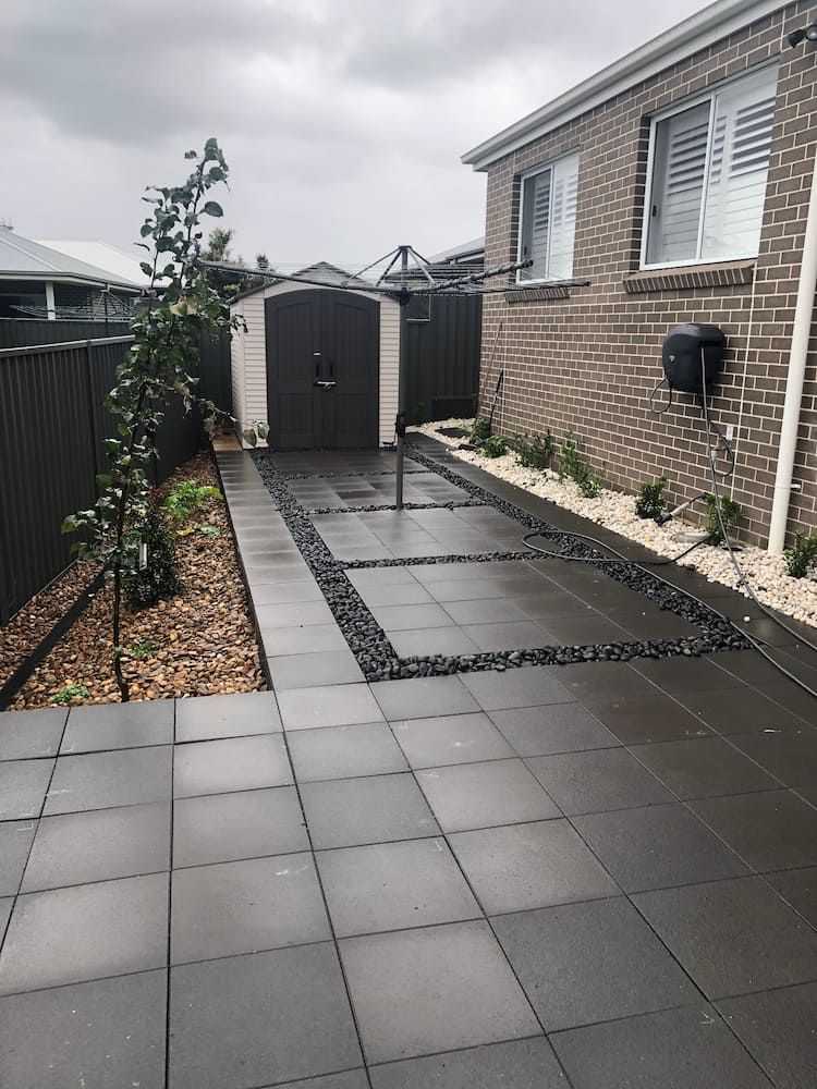A Brick House With a Patio in Front of It — Peter Phillips Landscape Design in Bomaderry, NSW