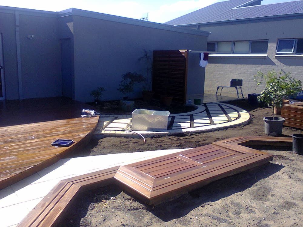 A House With a Wooden Deck in Front of It 