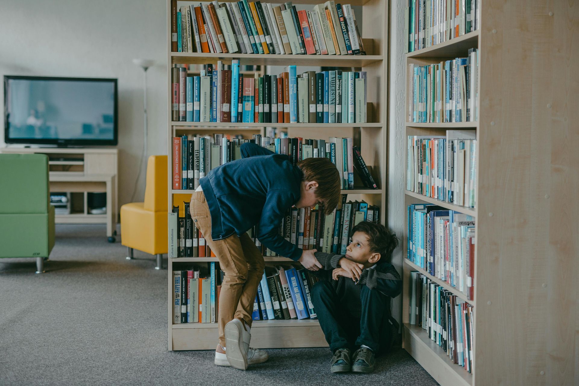A child is comforting another after they were bullied at school.