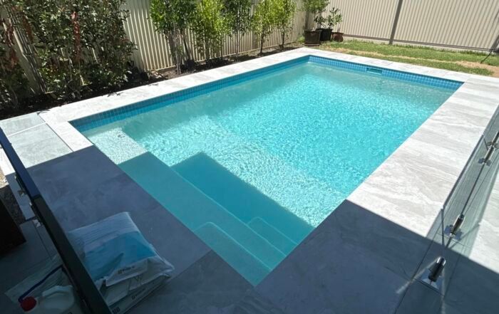 Rectangular Outdoor Swimming Pool with Turquoise Water — Mad Pool Interiors and Renovations in Baringa, QLD