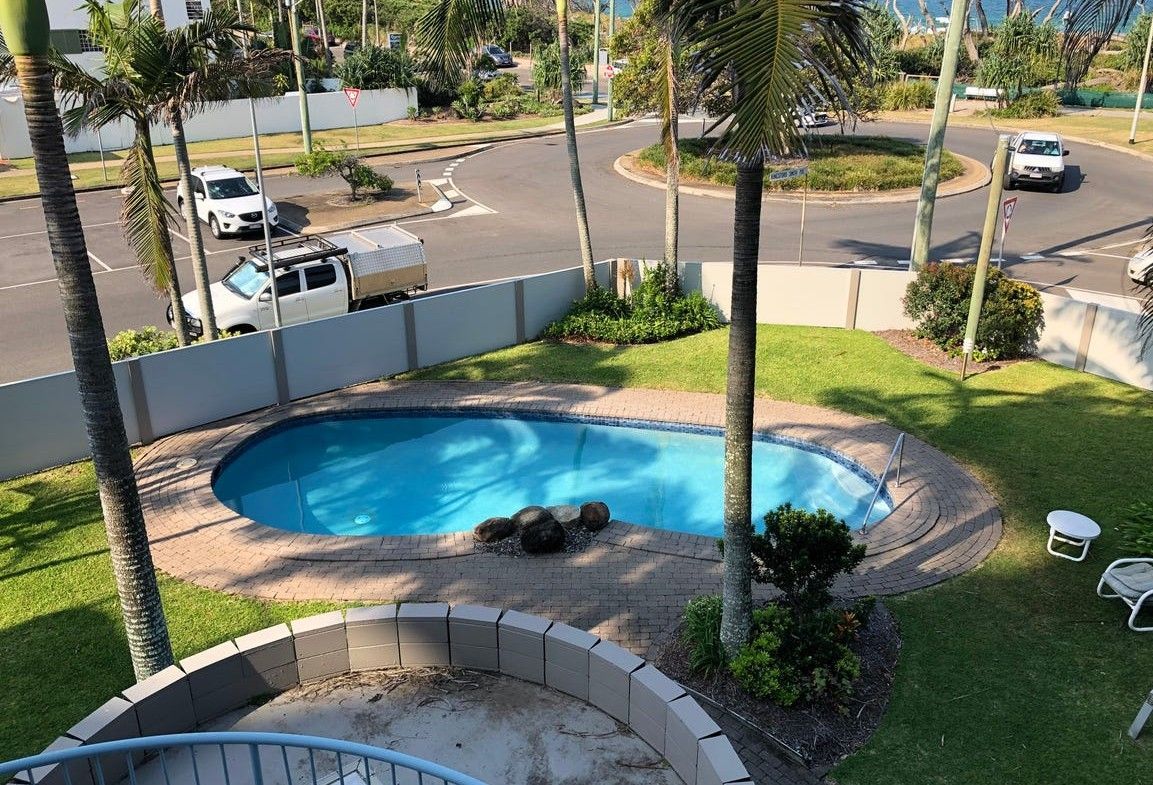 Courtyard Pool with Palm Trees and Surrounding Grass — Mad Pool Interiors and Renovations in Baringa, QLD