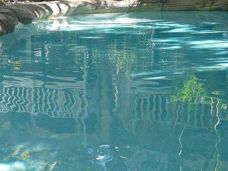 Water Surface Reflecting a White Fence — Mad Pool Interiors and Renovations in Baringa, QLD
