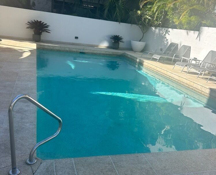 Outdoor Swimming Pool With Turquoise Water — Mad Pool Interiors and Renovations in Baringa, QLD