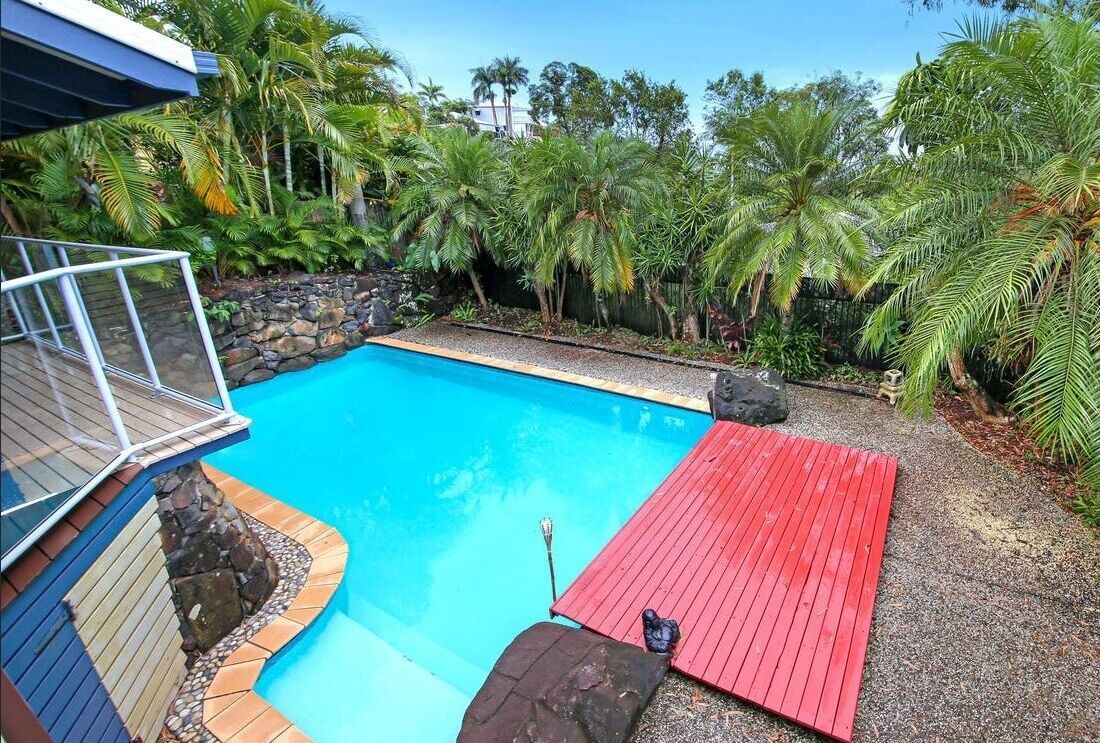 Backyard Pool With Bright Blue Water — Mad Pool Interiors and Renovations in Baringa, QLD