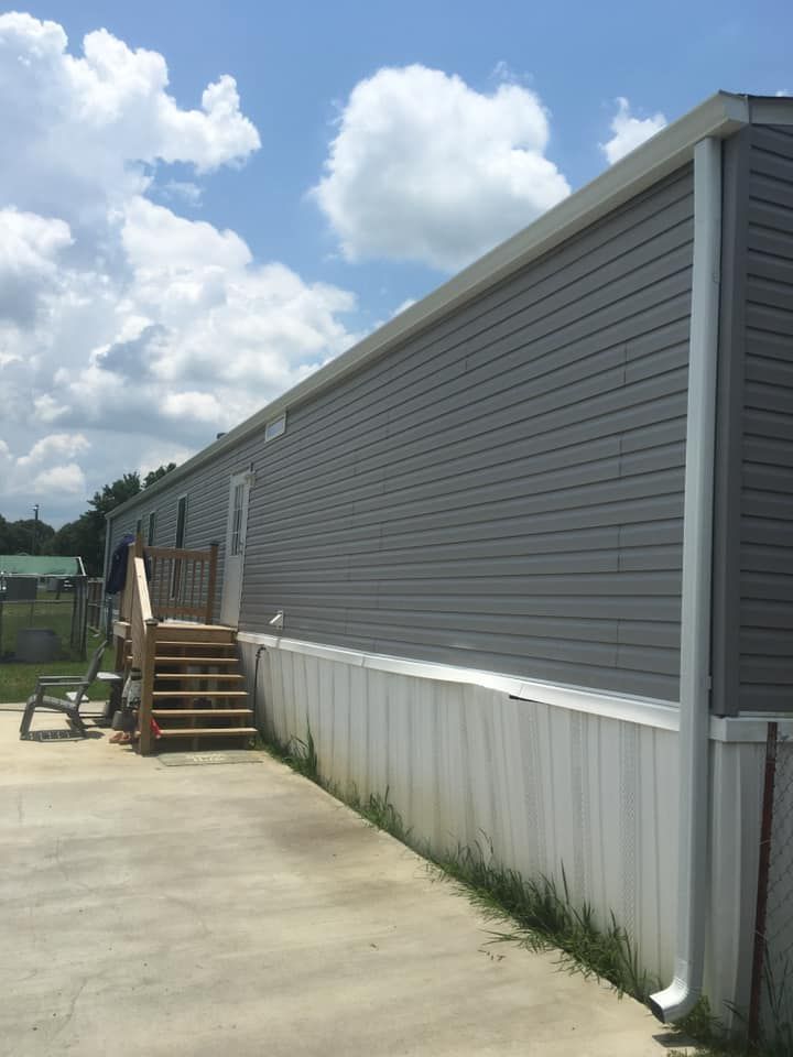 A mobile home with stairs on the side of it