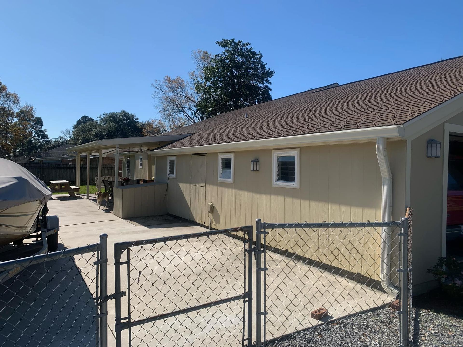 A house with a chain link fence surrounding it