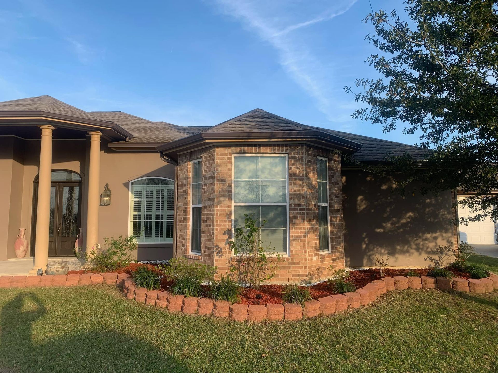 The front of a house with a tree in front of it