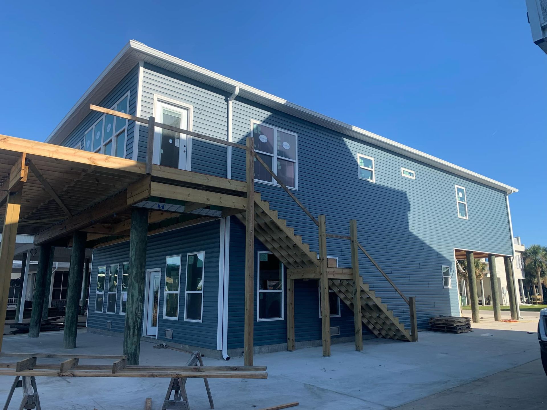 A large blue building with stairs leading up to the second floor.