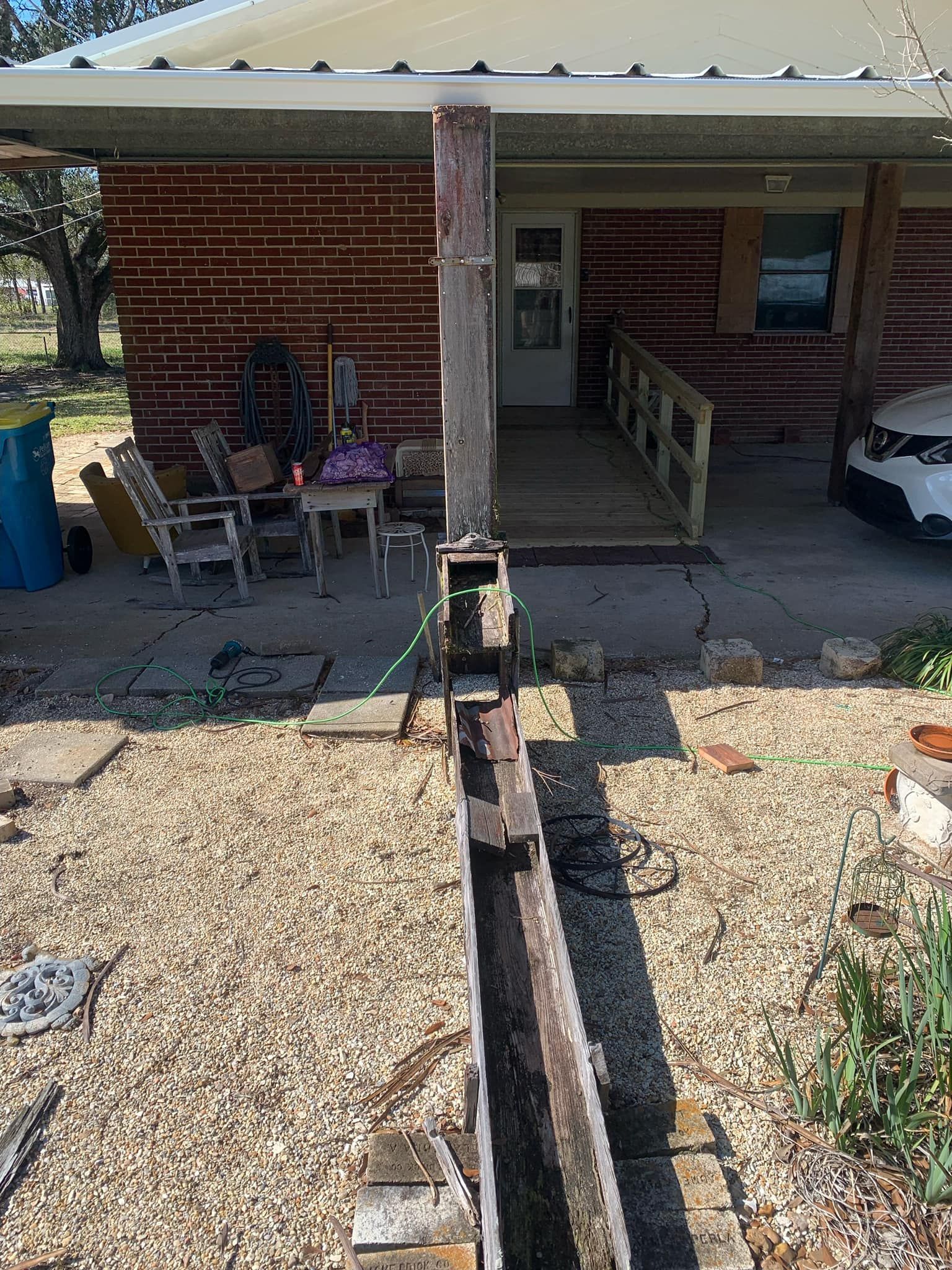 A log cabin with a car parked in front of it.