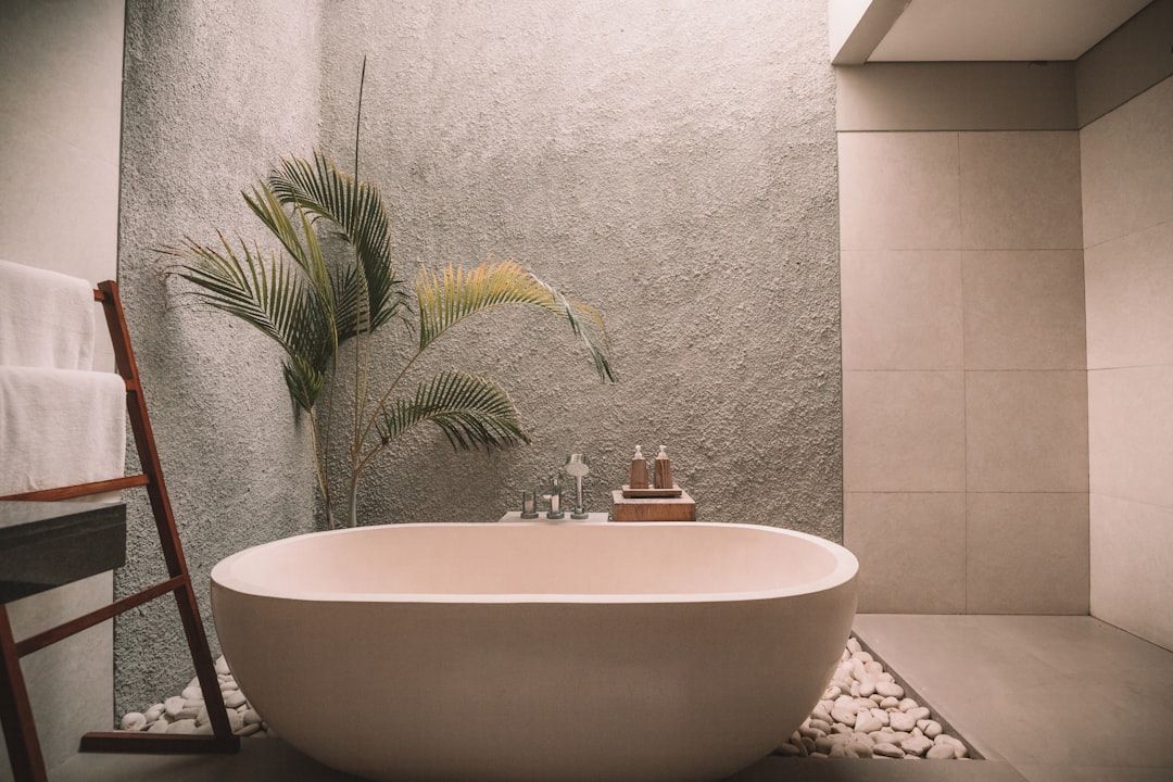 A bathroom with a bathtub and a towel rack.