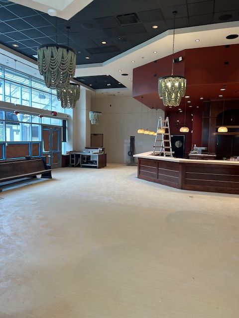 A large empty room with a wooden counter in the middle