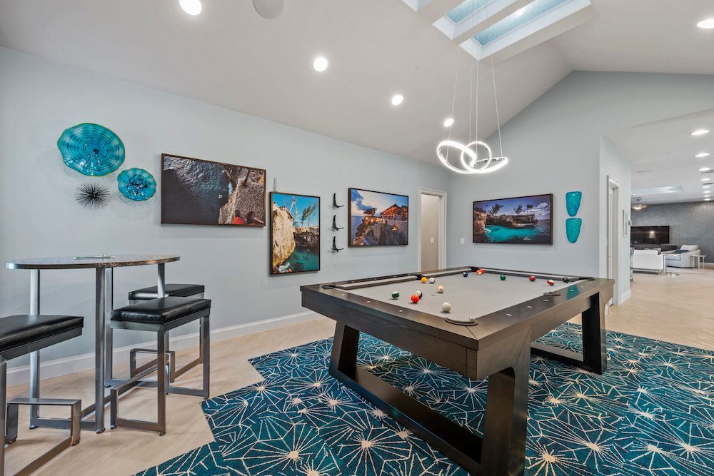 There is a pool table in the middle of the room.