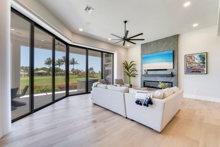 A living room with a fireplace and a flat screen tv on the wall.