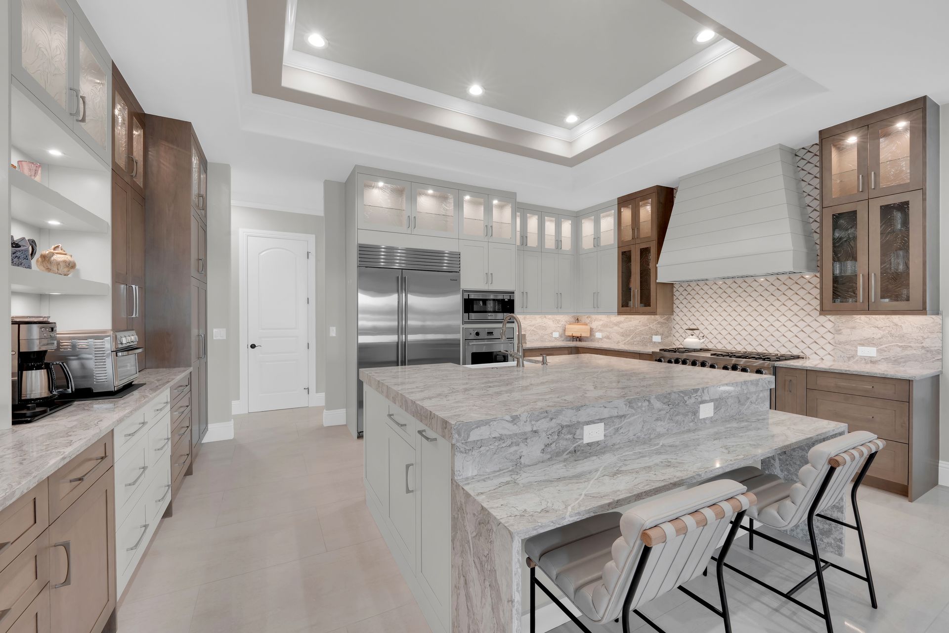 Modern kitchen with island, stainless steel appliances, and wood cabinets.