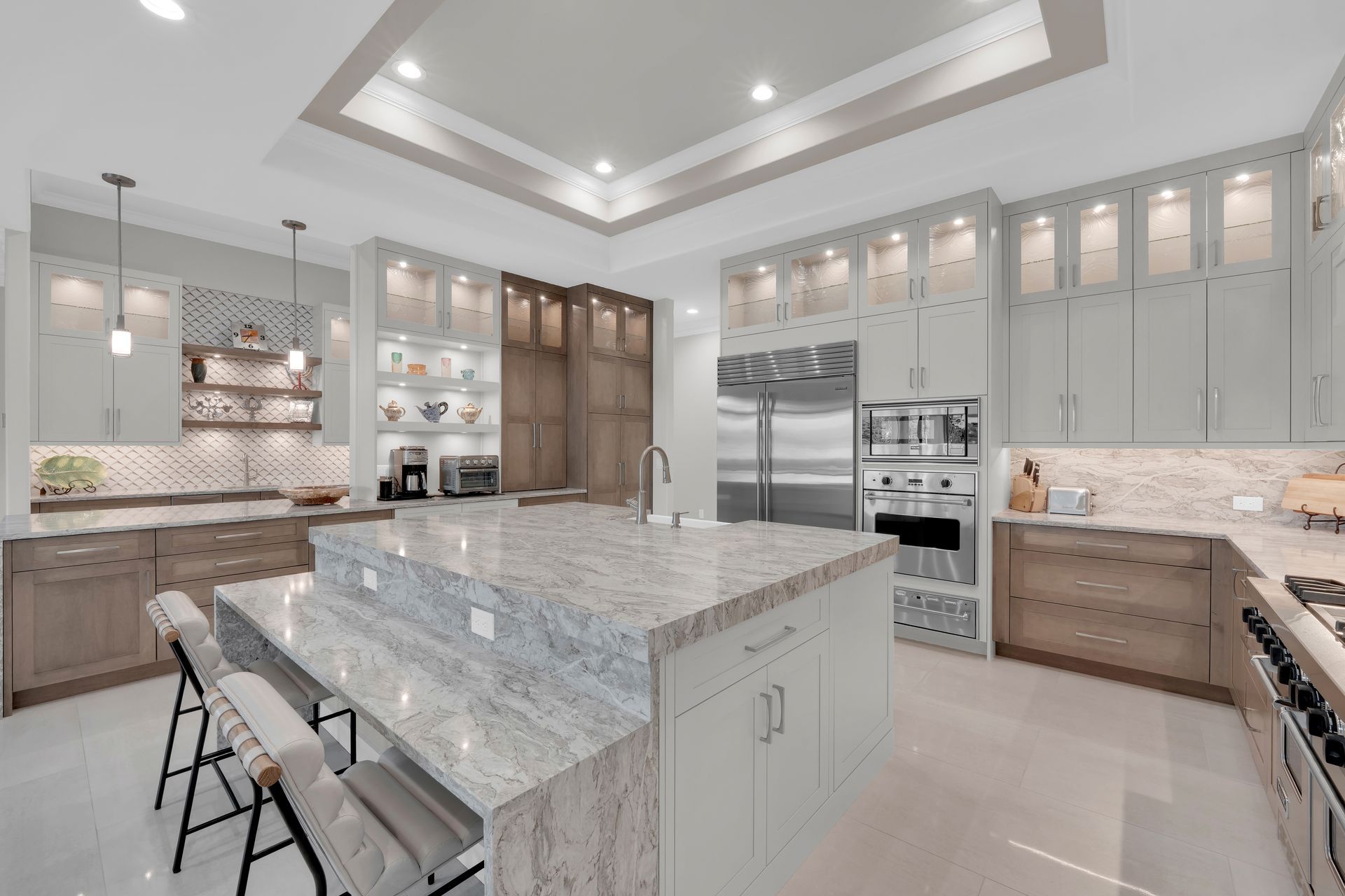 Spacious modern kitchen with a large island, stainless steel appliances, and light-colored cabinets.