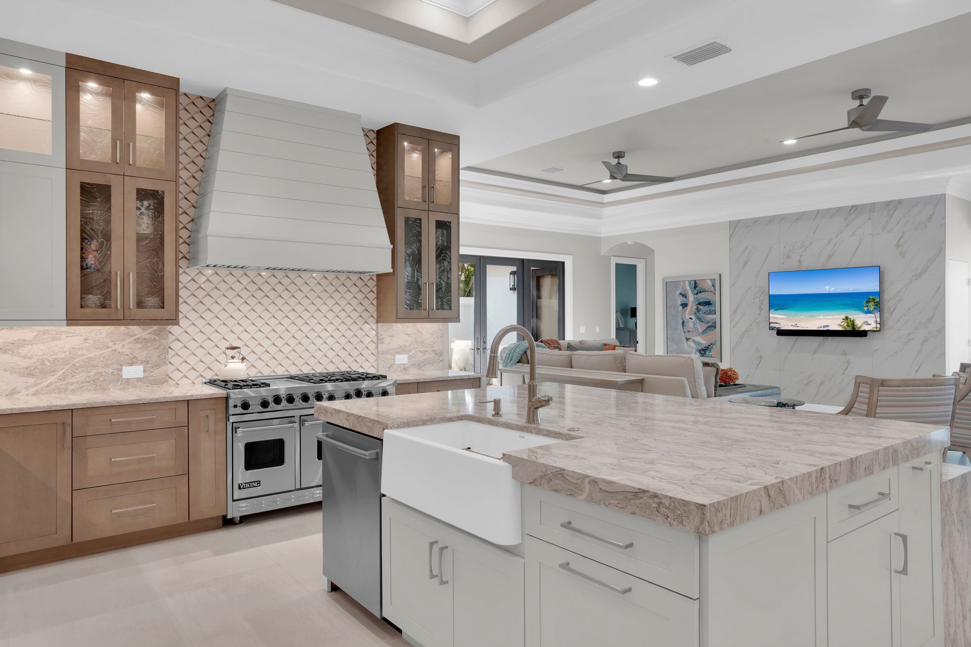 Elegant kitchen with island, range, and cabinets in neutral tones.