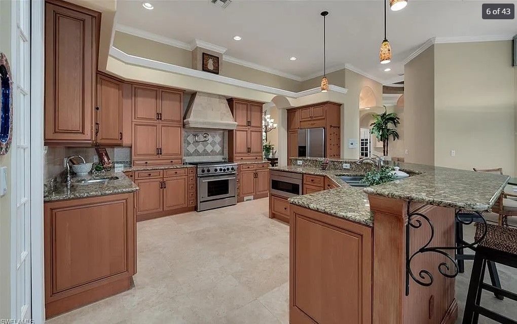 Spacious kitchen with wood cabinets, granite countertops, and stainless steel appliances.