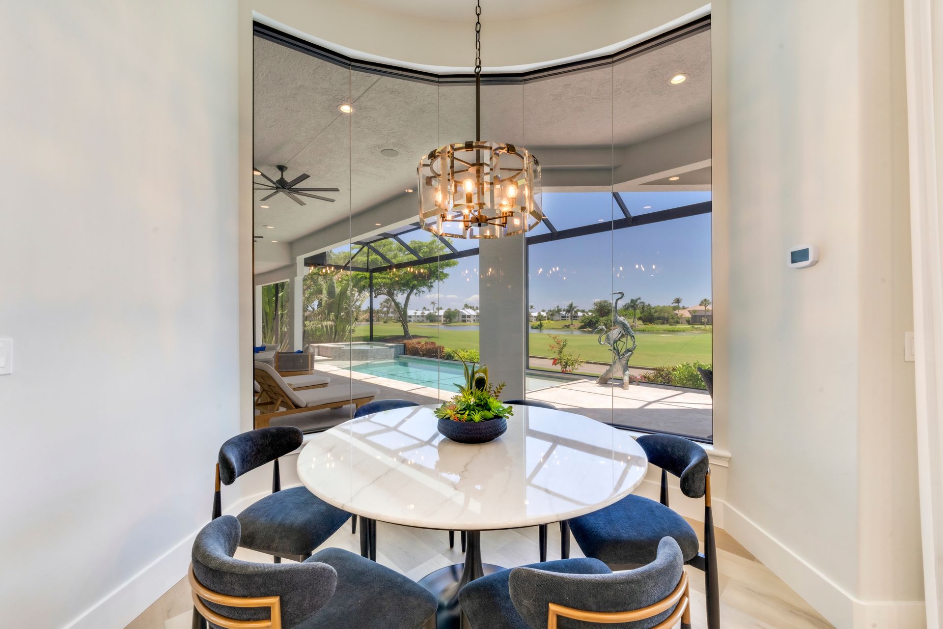 A dining room with a table and chairs and a chandelier.