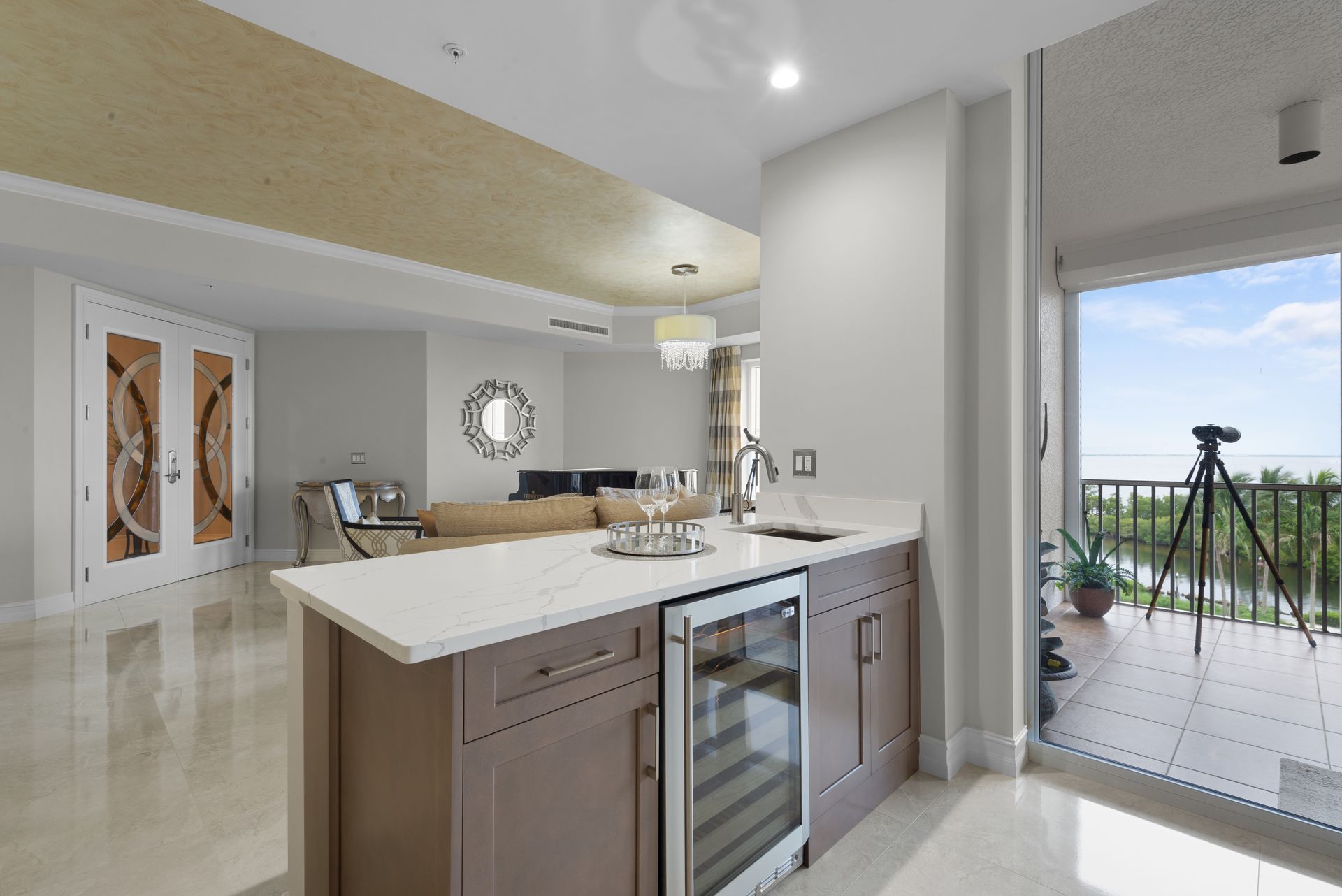 A kitchen with a large island and a refrigerator