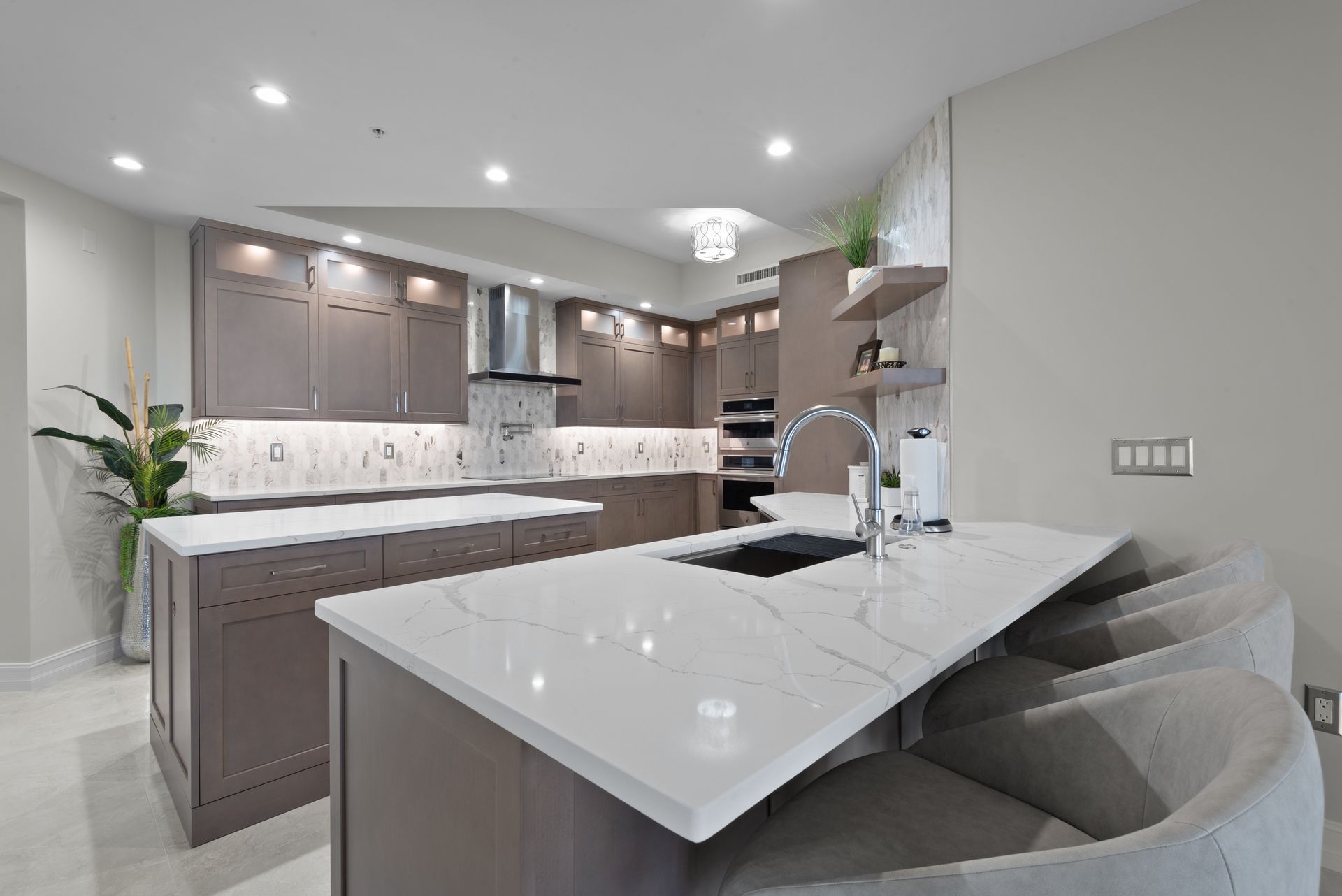 A kitchen with a large island and a sink.