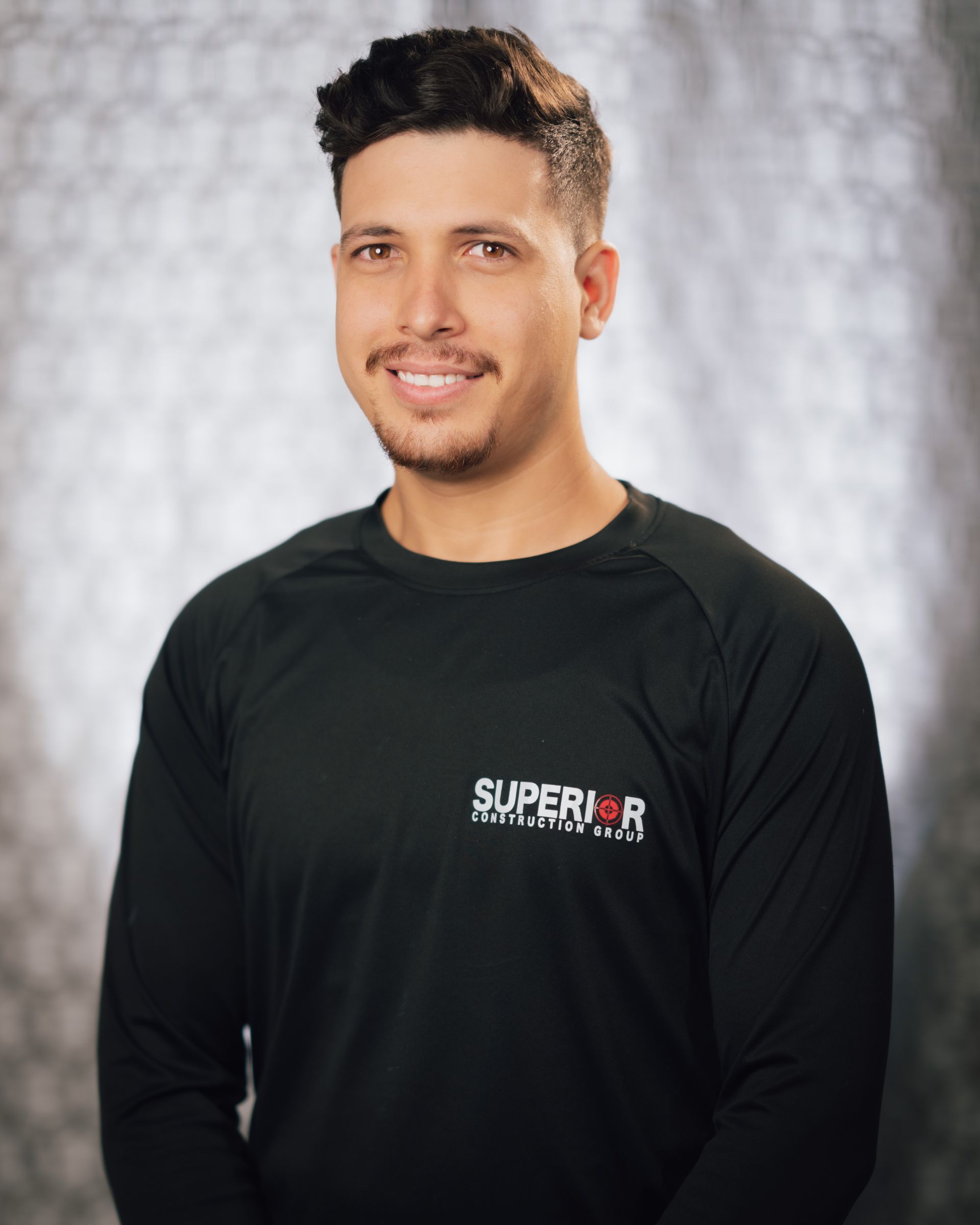 A man wearing a black shirt with the word superior on it