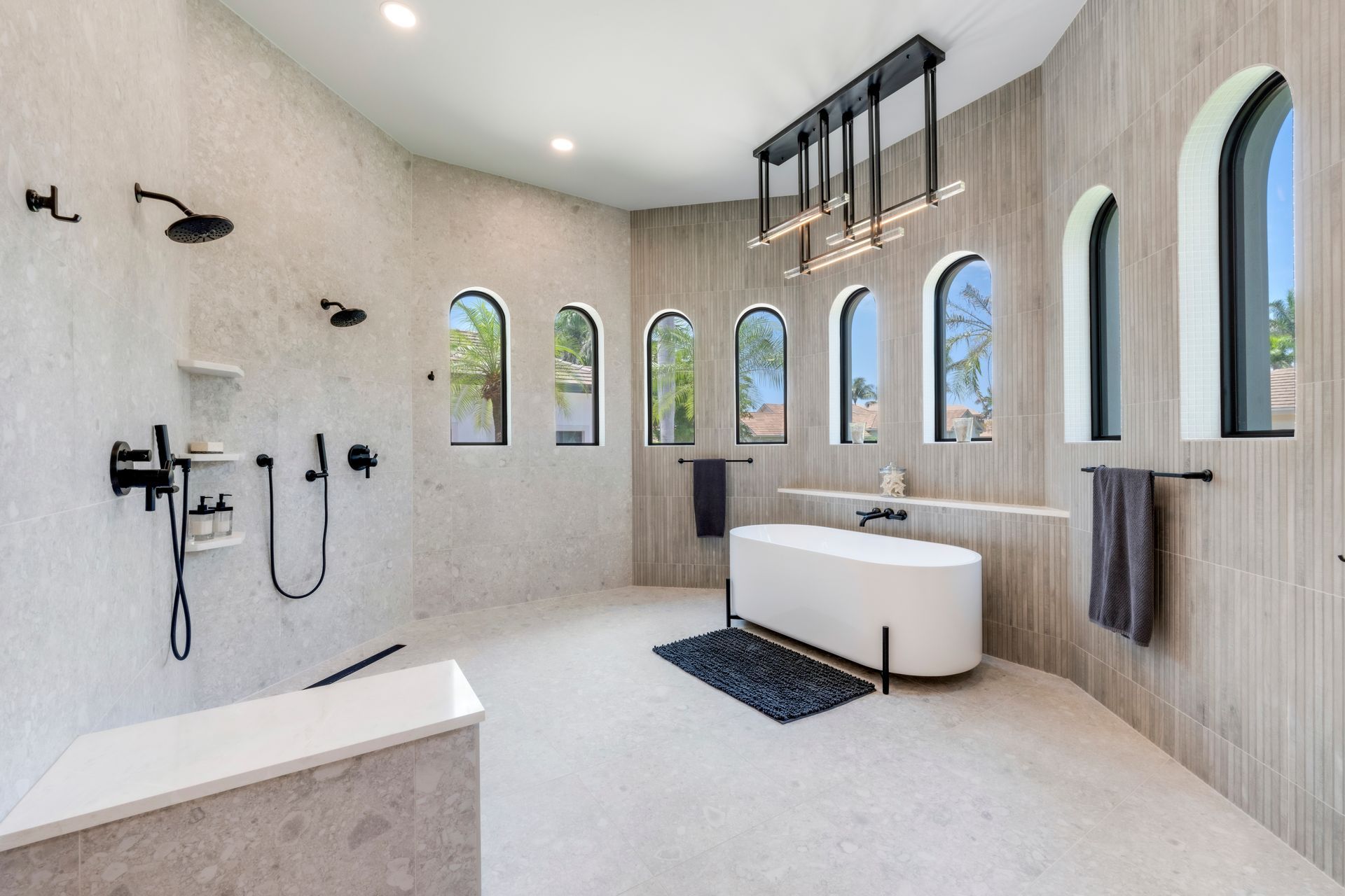 A bathroom with a bathtub , shower , and window.