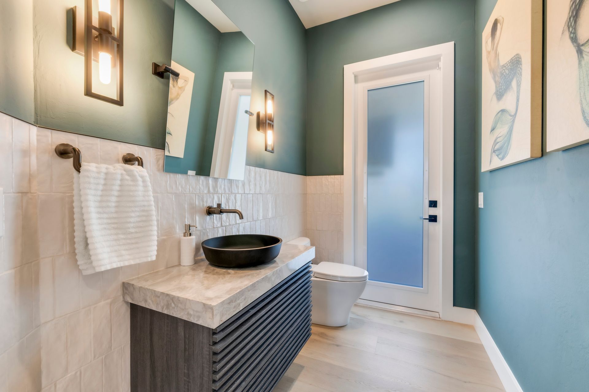 A bathroom with a sink , toilet and mirror.