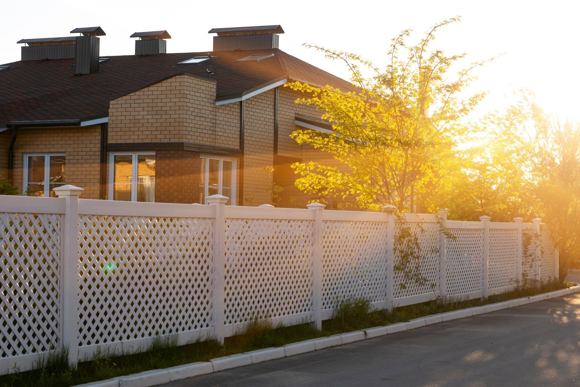 White plastic fence around a typical house in a cottage village