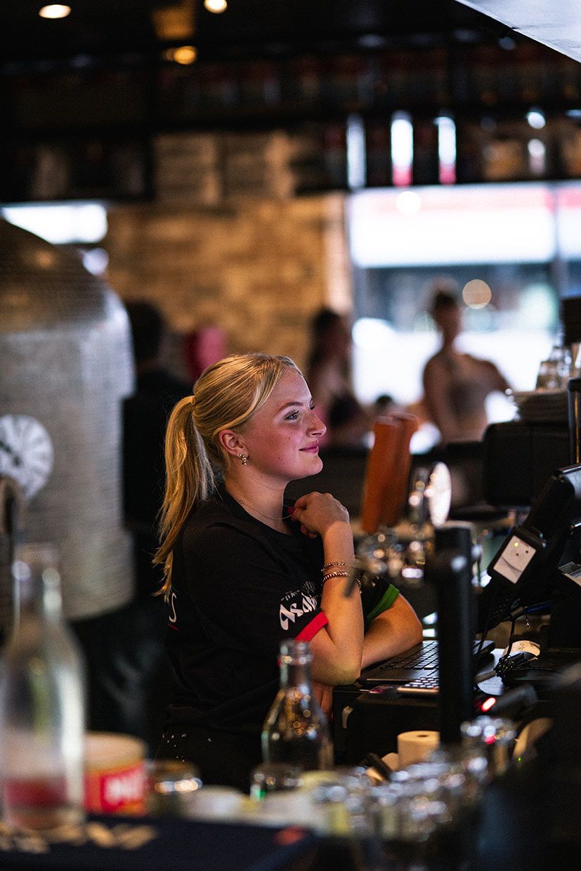 A Woman is Sitting at a Bar in a Restaurant — Fedeles East Gosford in East Gosford, NSW