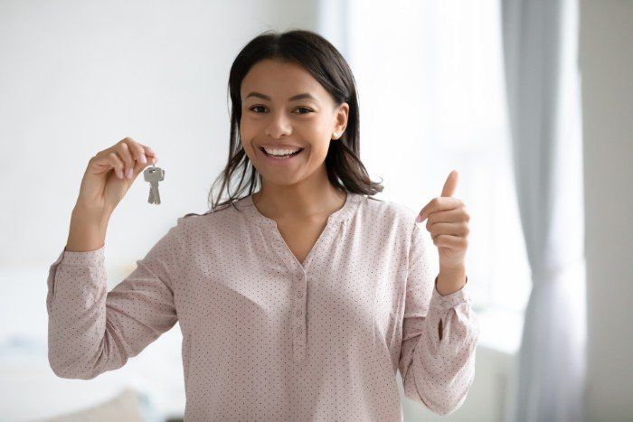 Happy tenant of furnished apartment holding keys